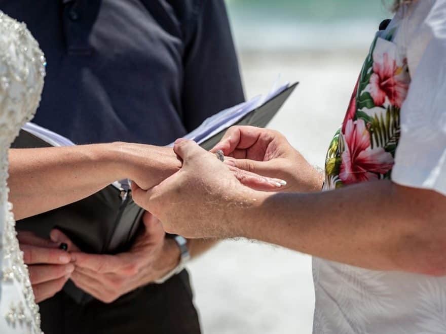 rob placing wedding ring on bride's finger