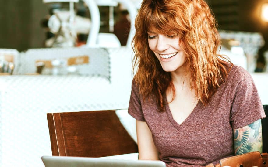 freelance writer writing on a laptop at a coffee shop