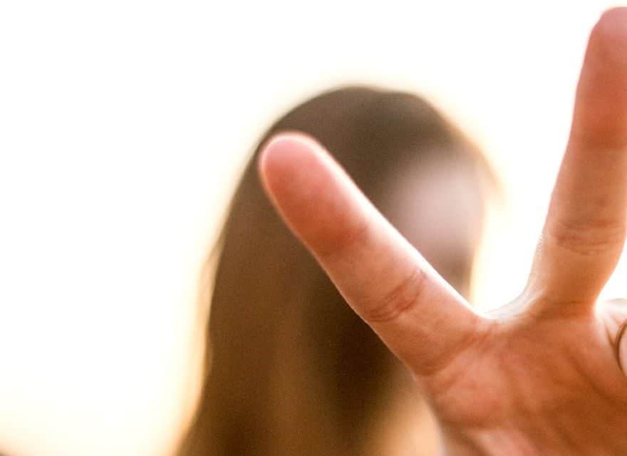 woman holding up two fingers