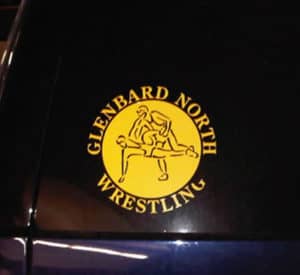 this logo for glenbard north wrestling appears to show two male wrestlers in an interesting sexual position