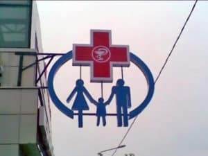 this logo for a health care clinic appears to show a family of three hanging by the necks from a red cross